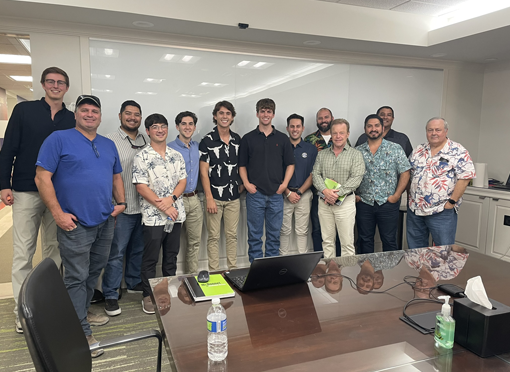 Group of McDonnel Group employees posing together in an office setting, showcasing teamwork and collaboration, reflecting the company's commitment to building careers in construction management.